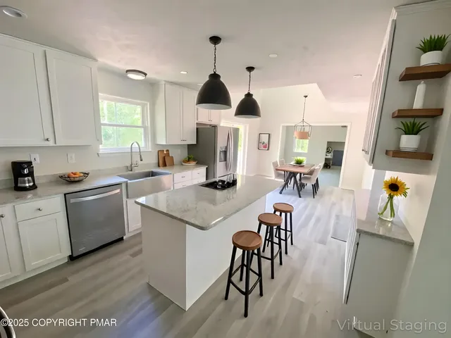 a kitchen with a refrigerator and a stove top oven