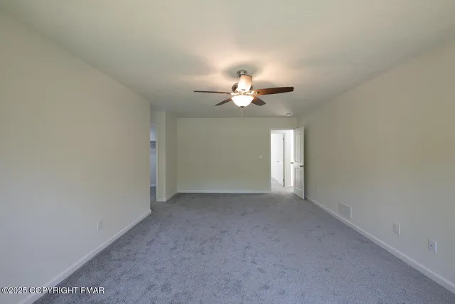 an empty room with a empty space and windows