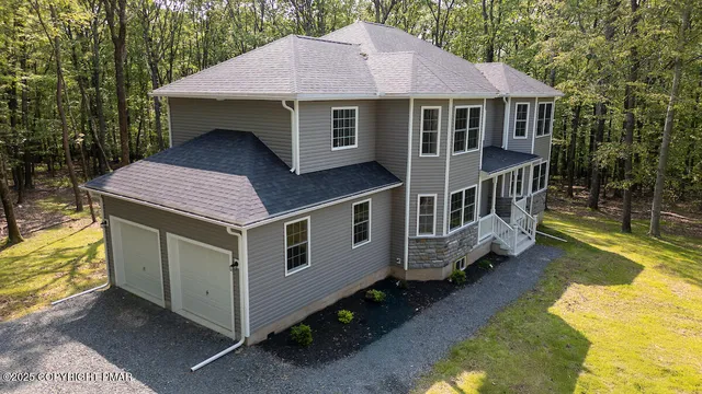 a aerial view of a house with a yard