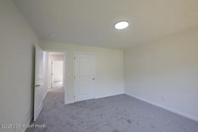 a bathroom with a sink a toilet and a window