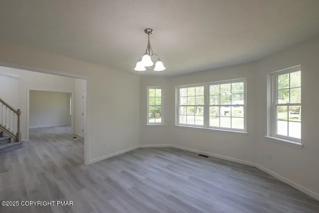 a view of a dining room with furniture and a potted plant