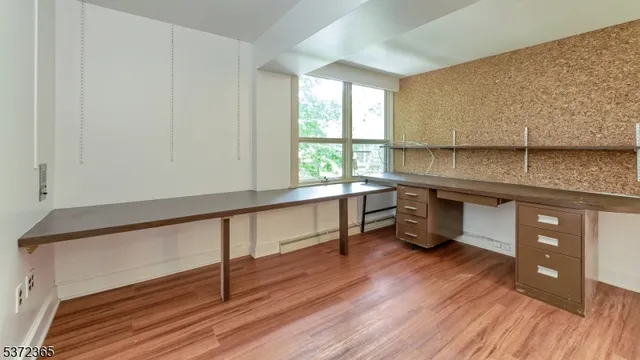 a kitchen with stainless steel appliances granite countertop a sink window and wooden floor
