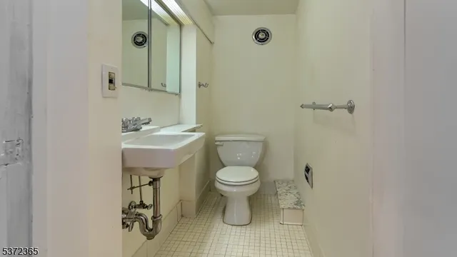 a bathroom with a toilet sink and shower