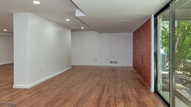 an empty room with wooden floor and doors