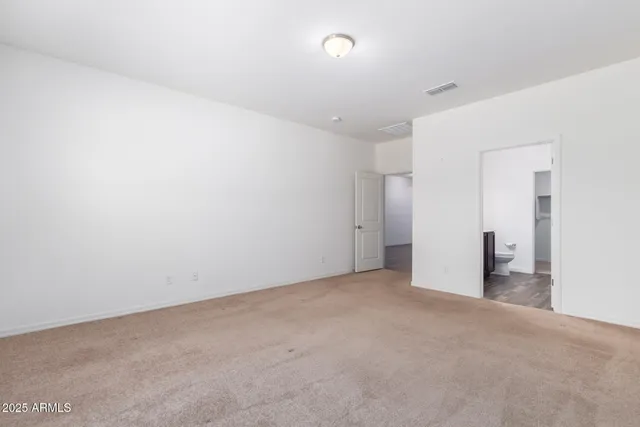 a bathroom with a sink a toilet and a large mirror