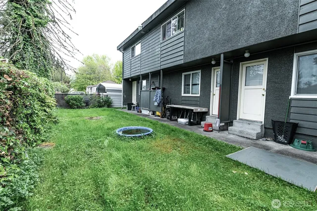 a view of a house with a yard and sitting area