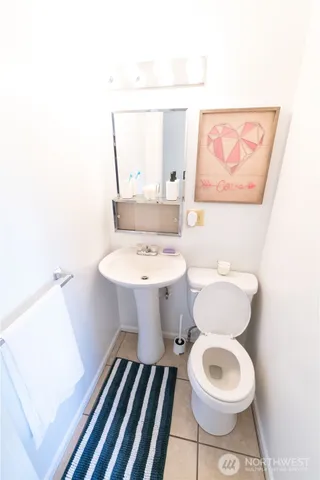 a bathroom with a sink toilet and mirror
