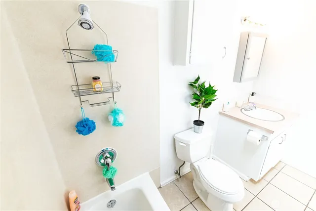 a white toilet sitting next to a bathroom sink