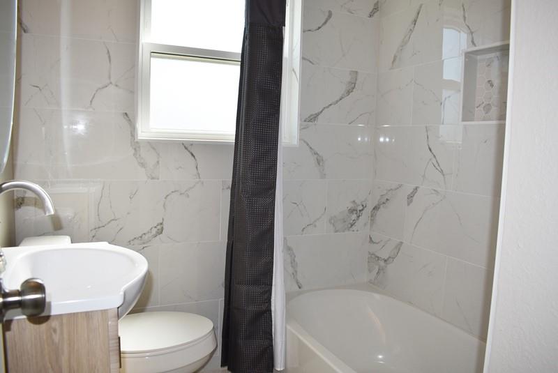 541 South Allen Street, Unit A Boyd, TX 76023 - Photo 11 of 15 a bathroom with a toilet and a bathtub