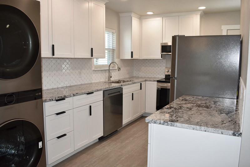 541 South Allen Street, Unit A Boyd, TX 76023 - Photo 5 of 15 a kitchen with stainless steel appliances granite countertop a sink stove and refrigerator