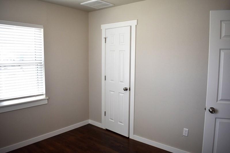 541 South Allen Street, Unit A Boyd, TX 76023 - Photo 9 of 15 a view of an empty room with wooden floor and a window