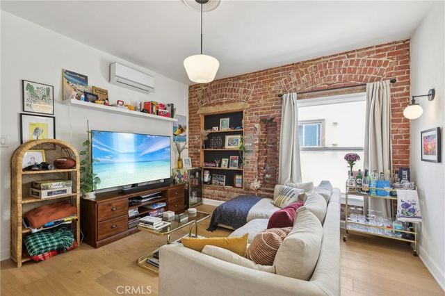 a living room with fireplace furniture and a flat screen tv