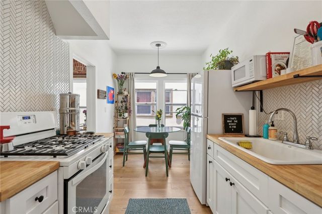 a kitchen with granite countertop a sink stove and cabinets