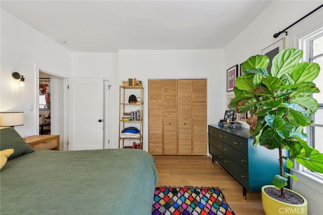 a bedroom with furniture and a potted plant