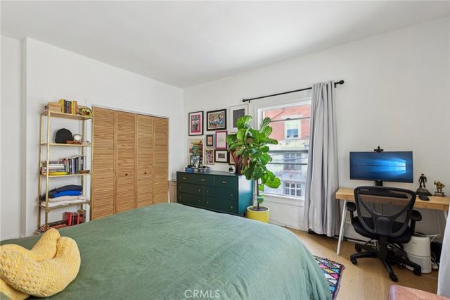 a bedroom with a bed and a desk