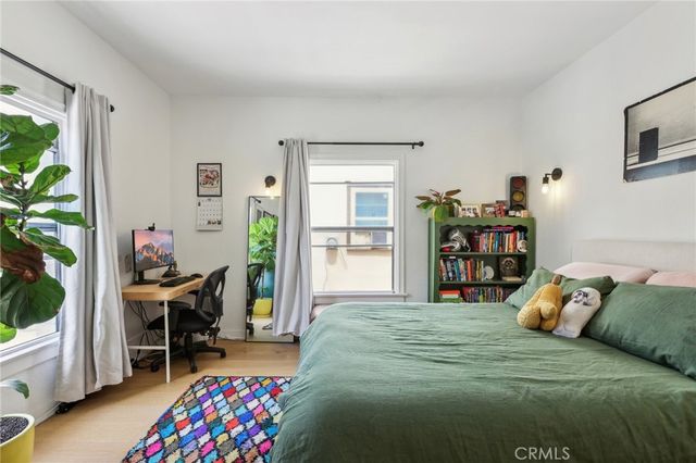 a bedroom with a bed and a bookshelf