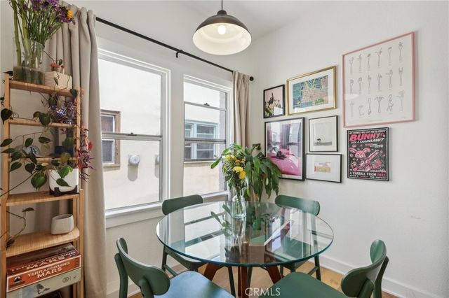 a dining room with furniture and wooden floor