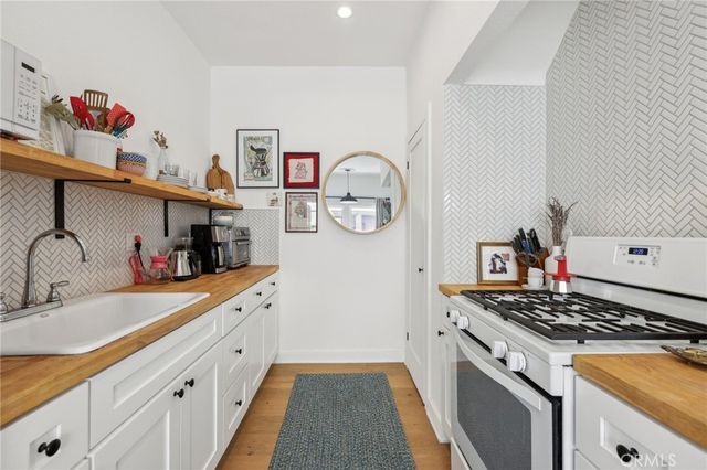 a kitchen with stainless steel appliances granite countertop a stove and a sink
