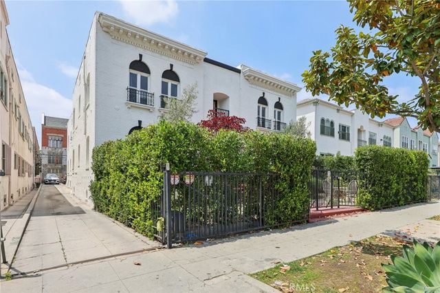 a kitchen with stainless steel appliances granite countertop a stove and white cabinets