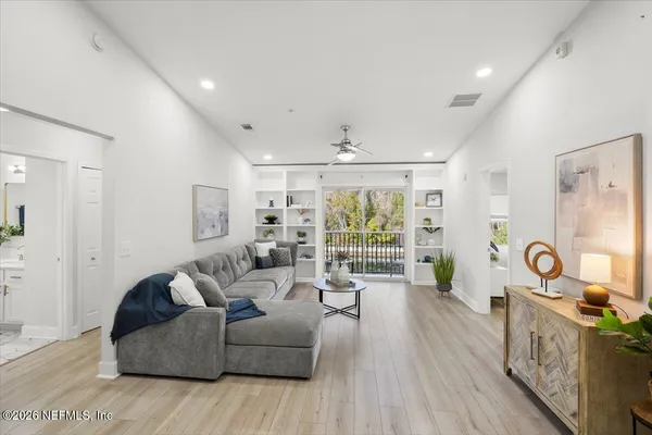 a living room with furniture and a large window