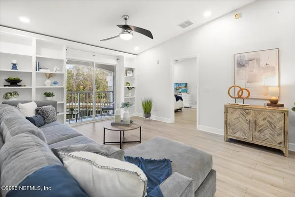 a living room with furniture and a large window