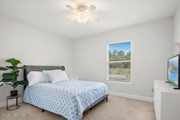 a bedroom with a bed and a television