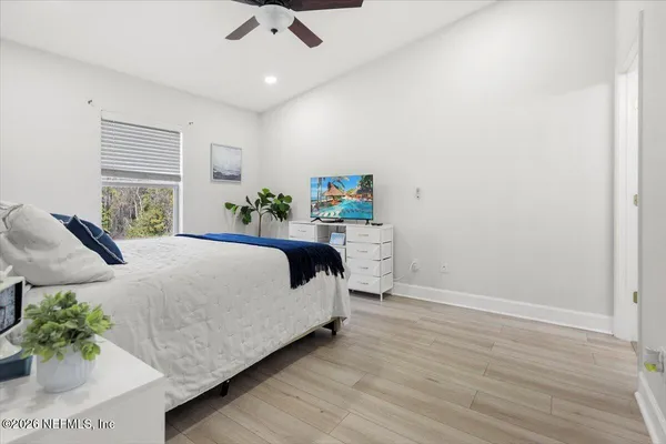 a bed room with a bed and a potted plant