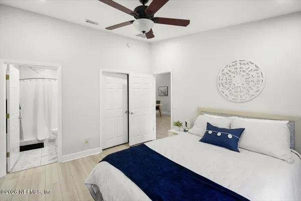 a room with a bed and a table with wooden floor