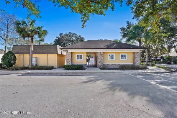 a view of house with swimming pool outdoor seating