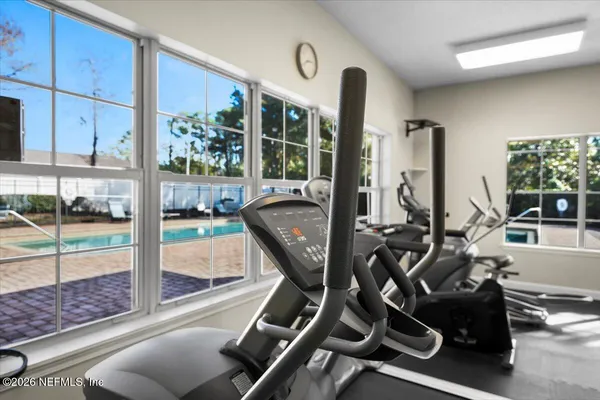 a room with gym equipment and a large window