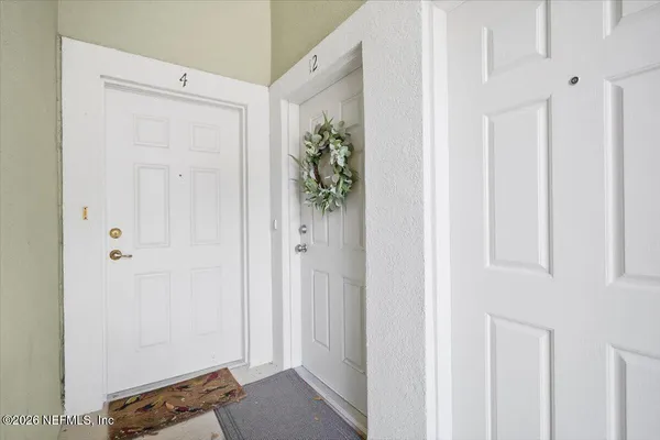 a view of bathroom with a closet and mirror