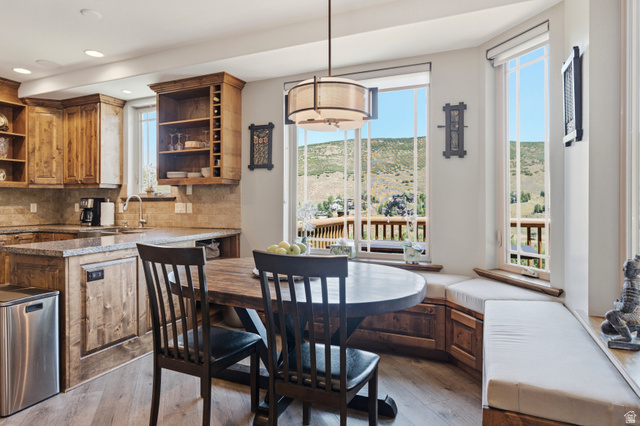 3148 Lower Saddleback Road Park City, UT 84098 - Photo 14 of 67 Kitchen and dining area featuring a built-in bench with storage, a circular wood-finish table, and wood-finish cabinetry