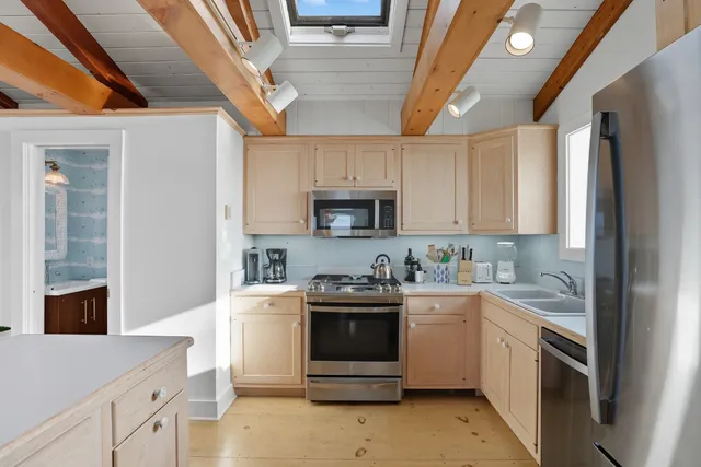 a kitchen with a sink a stove and refrigerator