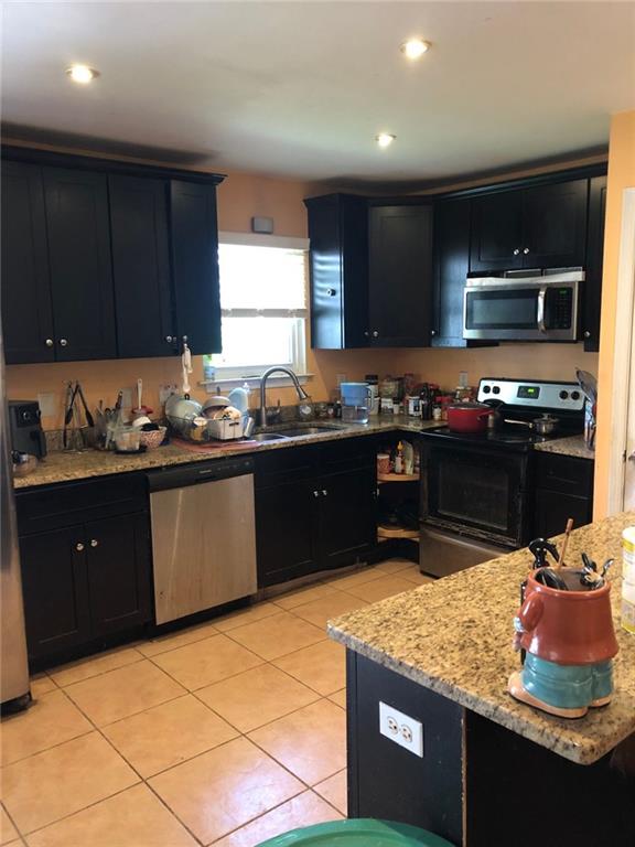 4064 Blanton Avenue Southwest Atlanta, GA 30331 - Photo 8 of 9 a kitchen with stainless steel appliances granite countertop a sink stove and refrigerator
