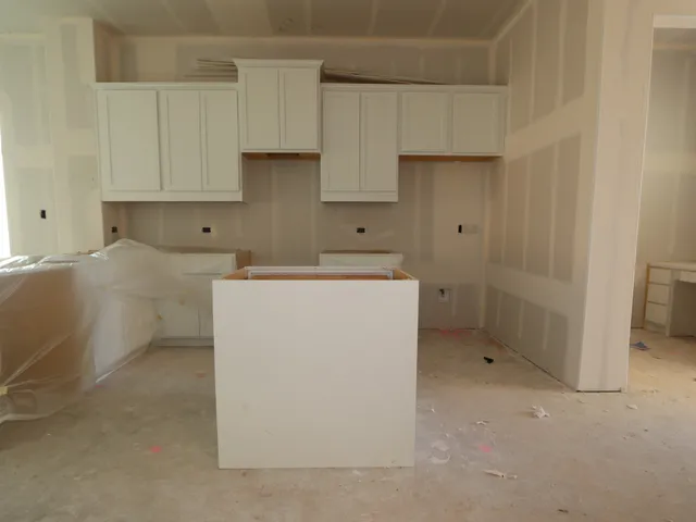a utility room with cabinets washer and dryer