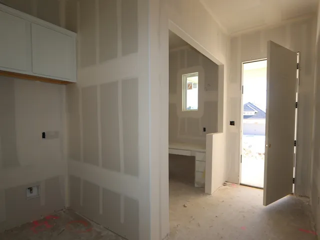 a view of a hallway with closet and bathroom