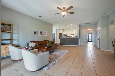 a living room with furniture and kitchen view
