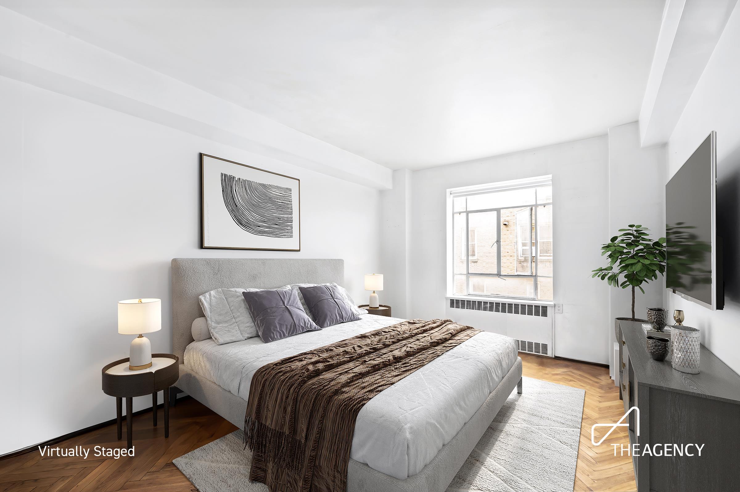 3 East 71st Street, Unit 2E Manhattan, NY 10021 - Photo 10 of 10 a bedroom with a bed a mirror and a potted plant