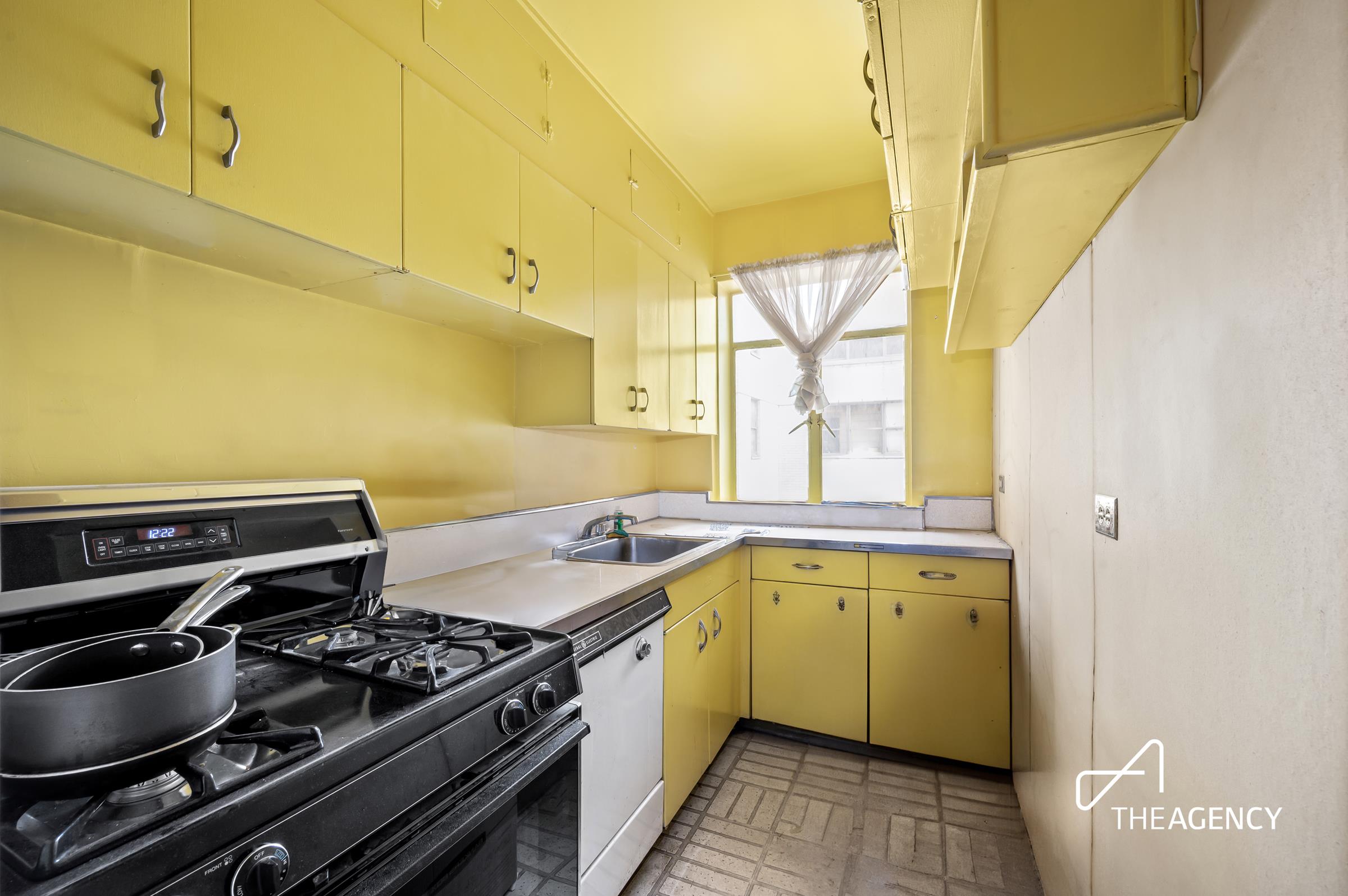 3 East 71st Street, Unit 2E Manhattan, NY 10021 - Photo 6 of 10 a kitchen that has a stove and a sink