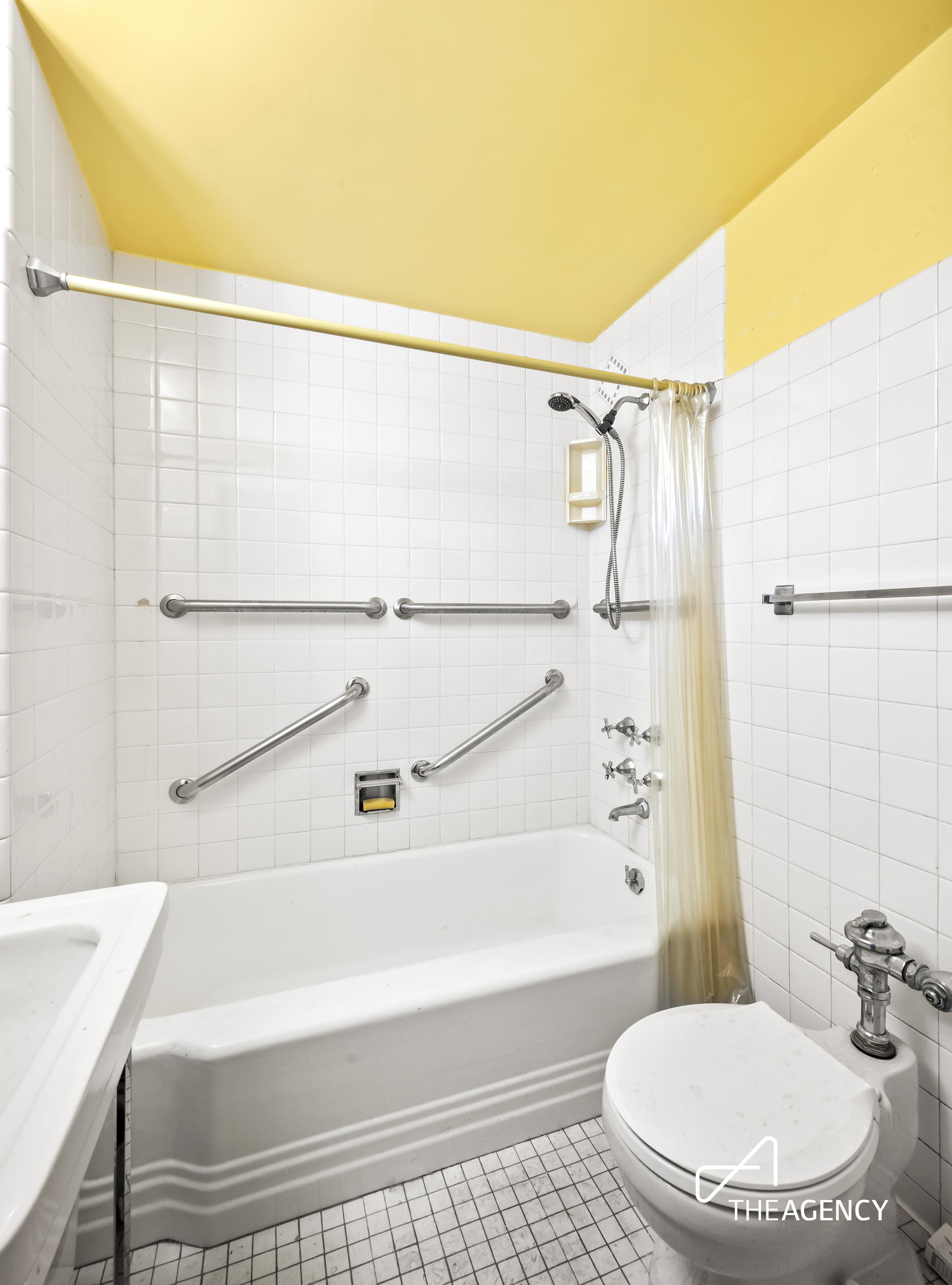 3 East 71st Street, Unit 2E Manhattan, NY 10021 - Photo 7 of 10 a bathroom with a toilet and a bathtub