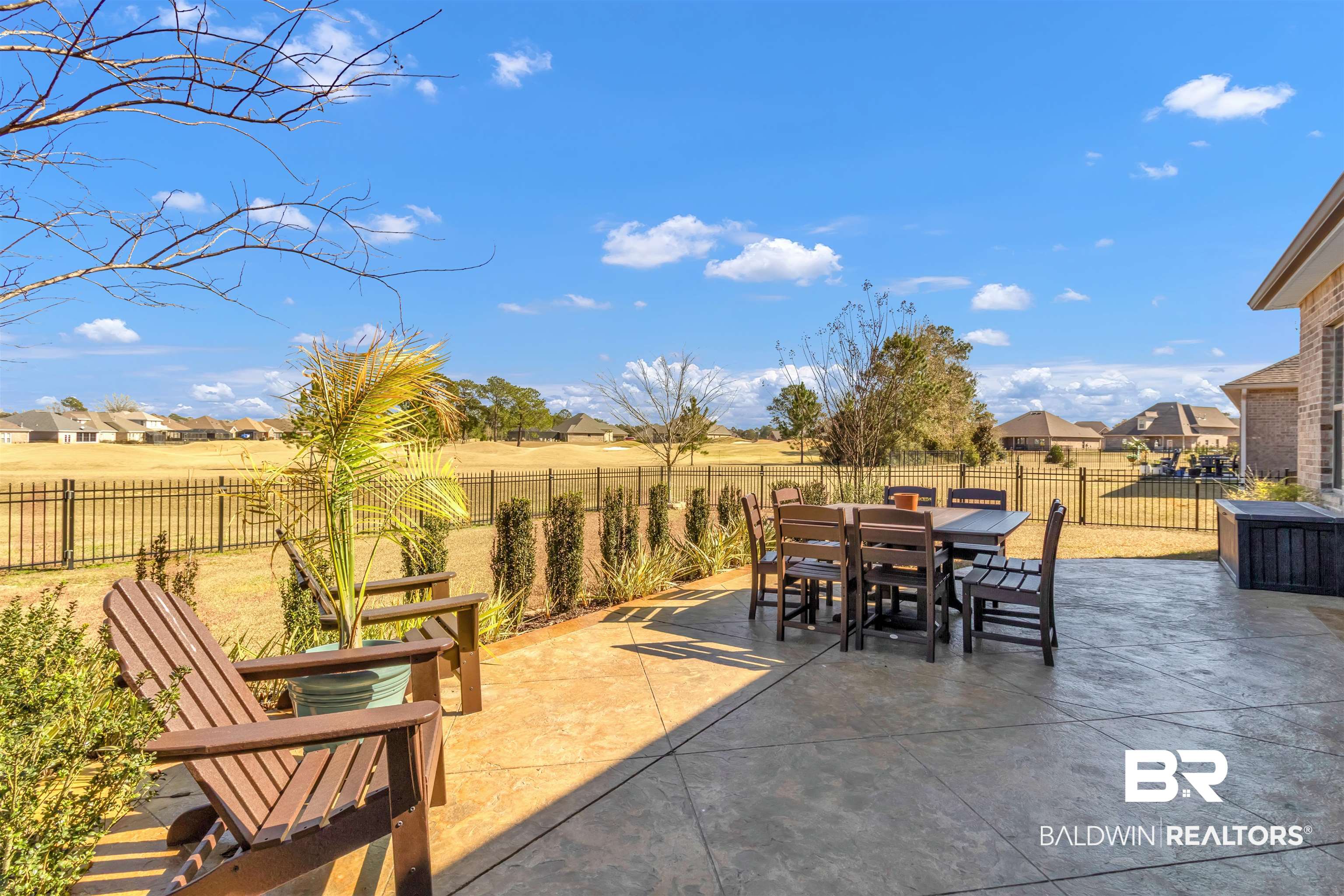 22531 Putter Lane Foley, AL 36535 - Photo 5 of 43 Fenced backyard with a residential view, outdoor dining area, and a patio area
