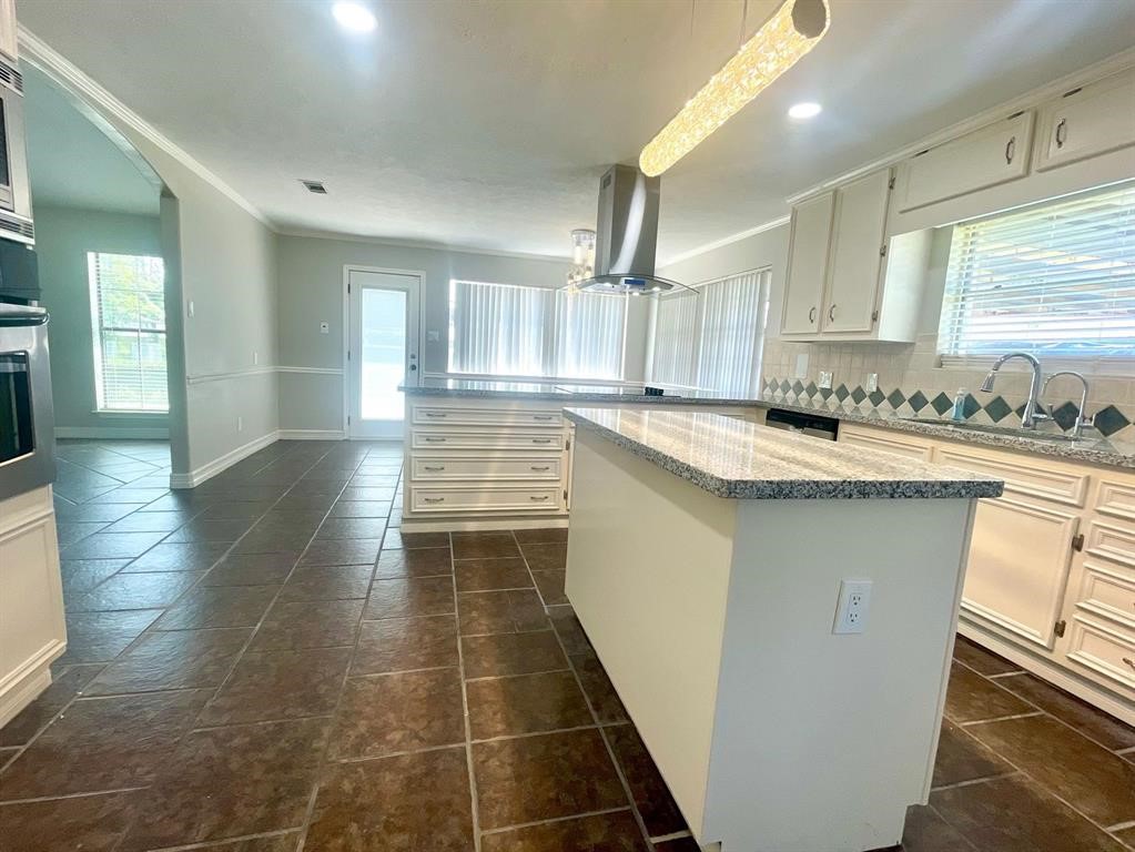 14221 Horseshoe Bend Conroe, TX 77384 - Photo 11 of 21 a kitchen with stainless steel appliances a sink stove and cabinets