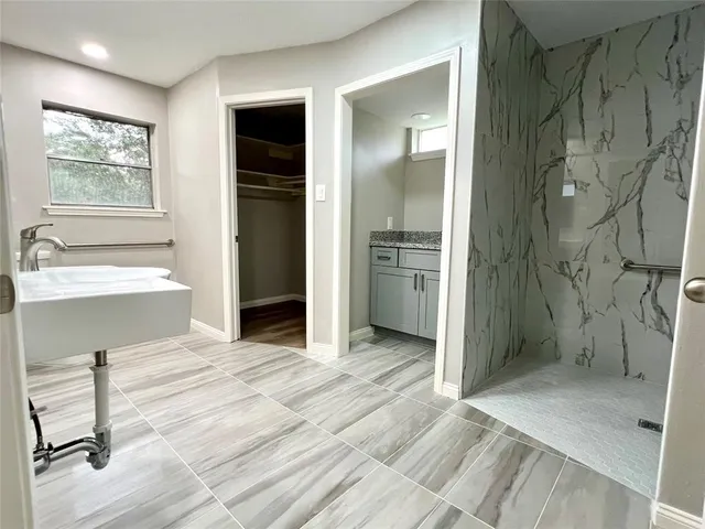a bathroom with a shower and a tub