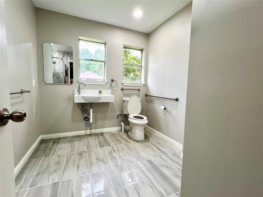 14221 Horseshoe Bend Conroe, TX 77384 - Photo 18 of 21 a bathroom with a sink toilet and a mirror