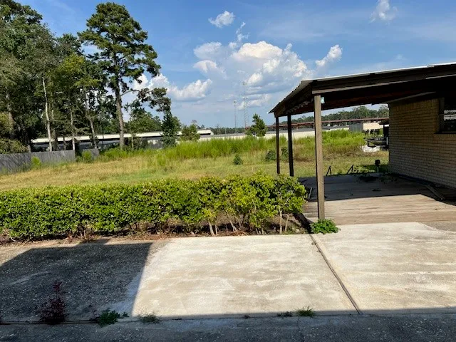 a view of a house with garden and trees
