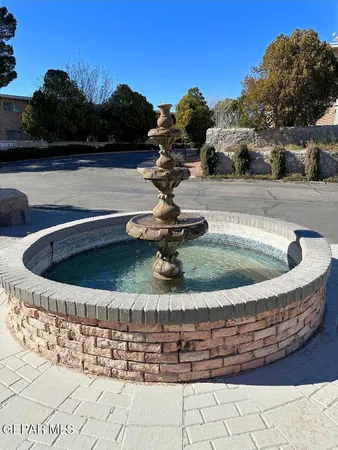 a living room with couches and projector with a rug