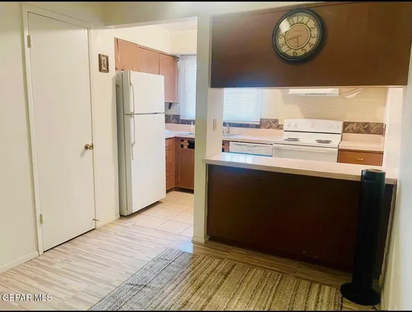 a kitchen with a sink a window and cabinets