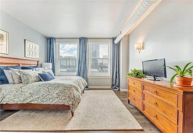 a bedroom with a bed and a potted plant