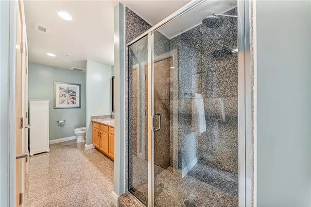 a bathroom with a double vanity sink mirror and toilet