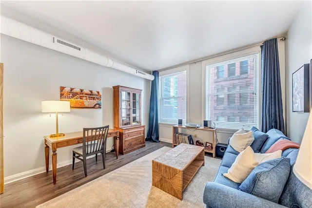 a living room with furniture and a wooden floor